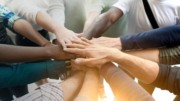 Innovative group creating a circle with their hands.